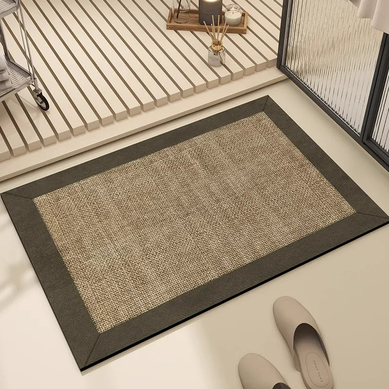 Tapis de sol en fibre naturelle avec bordure sombre, placé dans une entrée contemporaine avec un design minimaliste.
