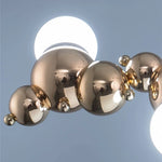 suspension lumineuse moderne doré blanc boules métalliques sphères translucides câble fixé nordique éclairage intérieur