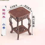 table basse bois rose classique gravures artisanal marron clair pot plante figurine cadre photo