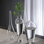 vases verre transparent modernes élégants branches feuilles roses arrangements floraux table maison mariage