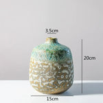 vase céramique rustique vert beige marron texturé variations couleur branches feuilles arrangement floral