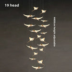 suspension lumineuse or oiseaux stylisés contemporaine minimaliste salon chaînes fixations métal lumière blanche chambre