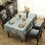 Une belle table de salle à manger avec des motifs floraux élégants, des chaises rembourrées et un meuble vintage décoré dans un style classique.