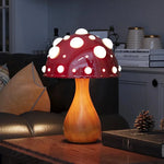 Lampe LED champignon Amanite allumée avec éclairage chaud sur table de chevet