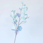 bouquet artificiel feuilles ovales moderne vase transparent support doré couleurs vives exposition intérieure