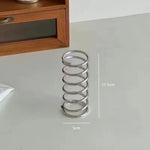 support brosse dents spirale argentée adhésif minimaliste inclusion pinceau parfum salle bains