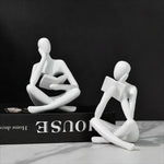 figurine deco moderne or noir blanc personne assise livre socle chambre abstraction minimalisme