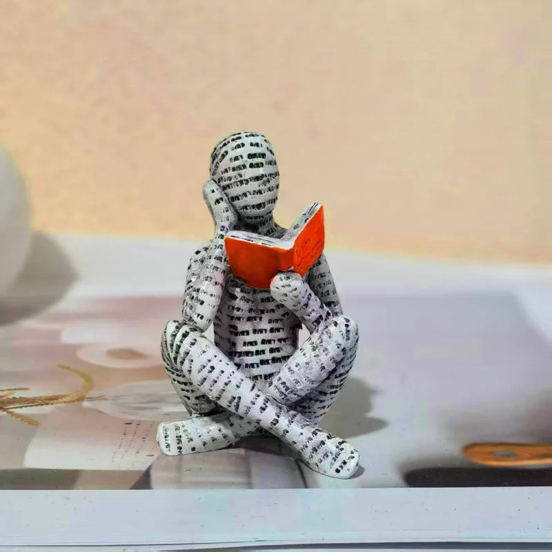 figurines decoratives modernes personnages lisant livres piles livres beige blanc orange minimaliste