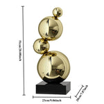 Sculpture décorative moderne or argent sphères polies métal base noire minimaliste