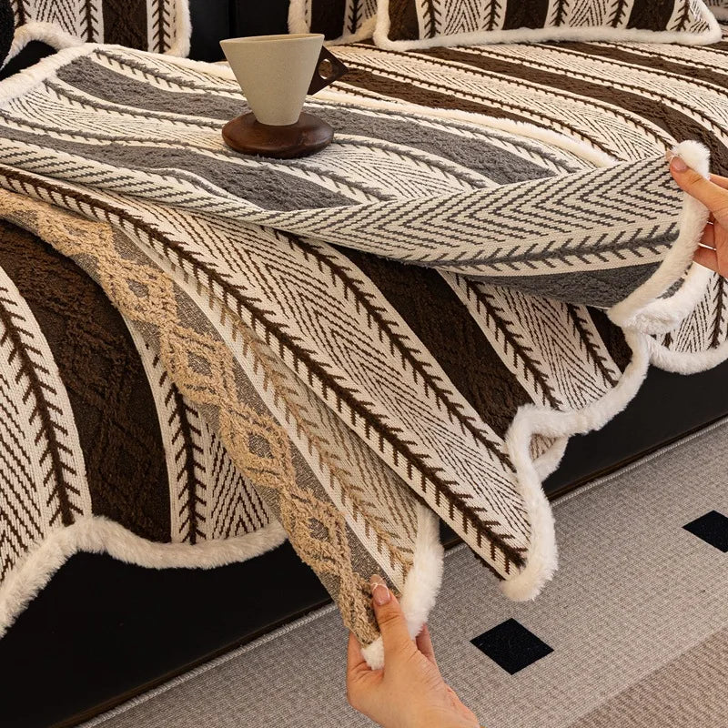 Une couverture en tissu tissé à la main, dotée de motifs géométriques et de textures douces, offrant un élément de confort et de style dans un intérieur moderne.