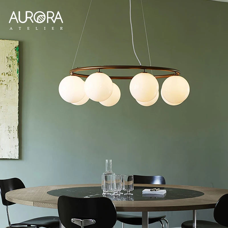 suspension lumineuse moderne câbles suspendus sphères translucides dorées blanches salon restaurant