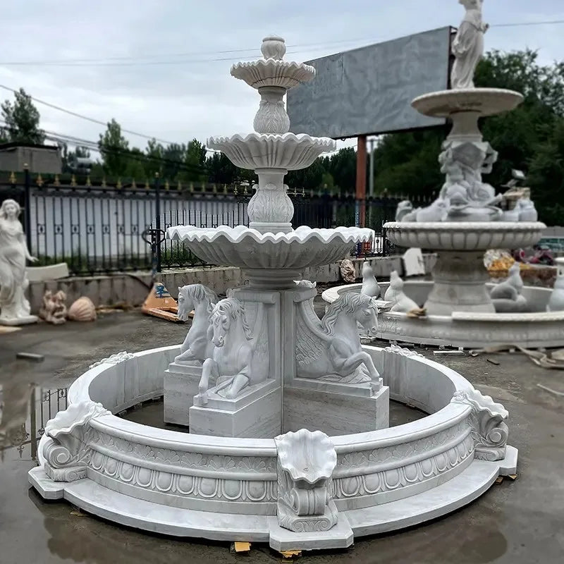 fontaine blanche sculptée motifs floraux animaux classique jardin extérieur ornements décorationextérieur sophistication designunique pierrequalitésupérieure
