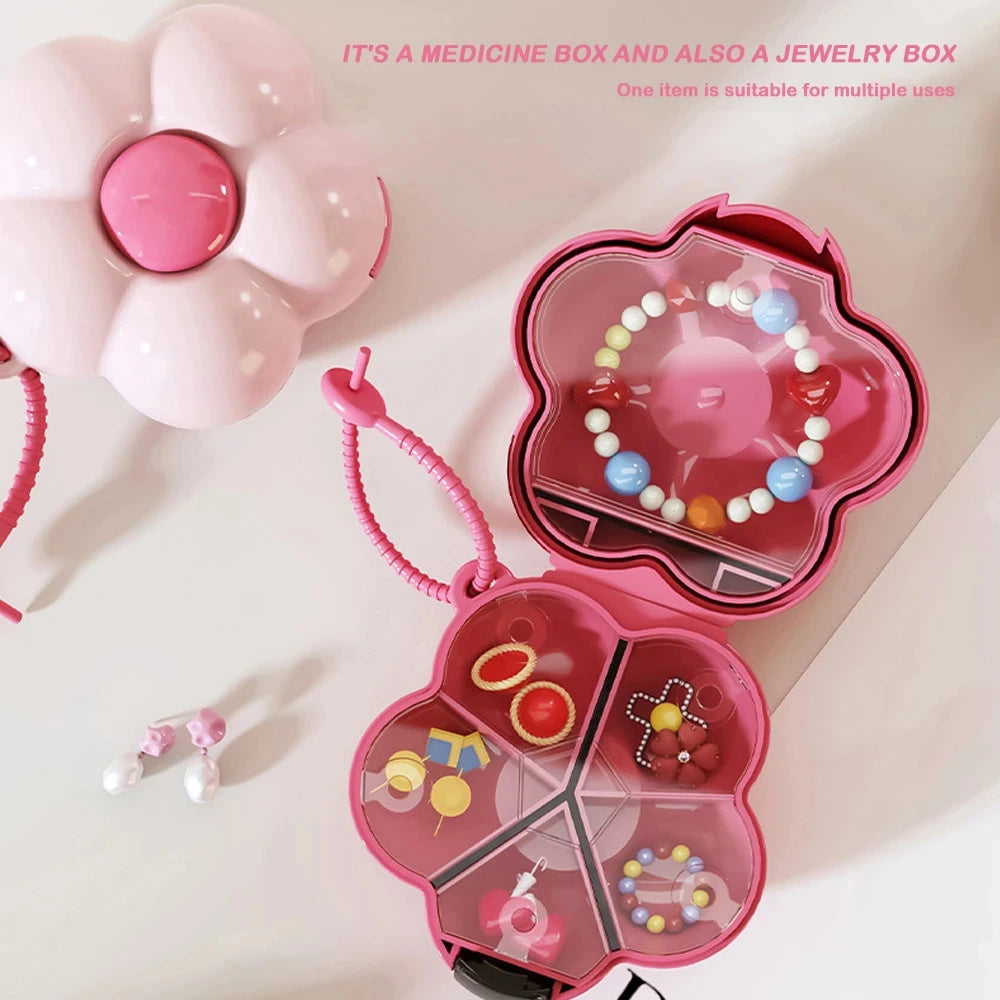 boîte pilules fleur rose moderne compartiments visibles anneaux bijoux élégante pratique