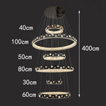 chandelier suspendu moderne plusieurs niveaux anneaux cristal transparents noir doré