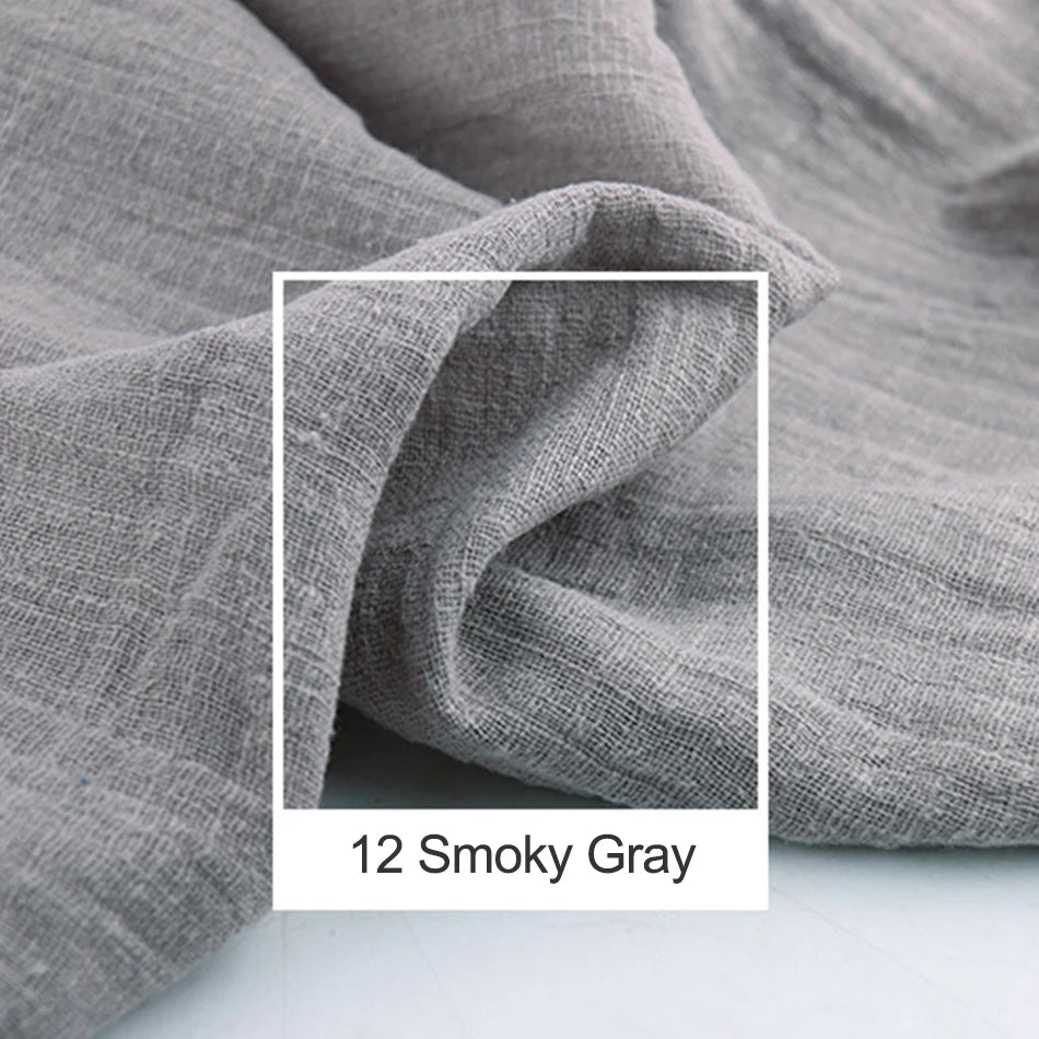 Cette image en noir et blanc montre un tissu chiffonné avec des plis et des ombres, donnant une texture et une ambiance douces et apaisantes dans une teinte grise légèrement fumée.