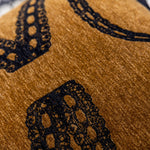 Une texture en relief noire sur un fond doré foncé, créant un motif élégant et décoratif.