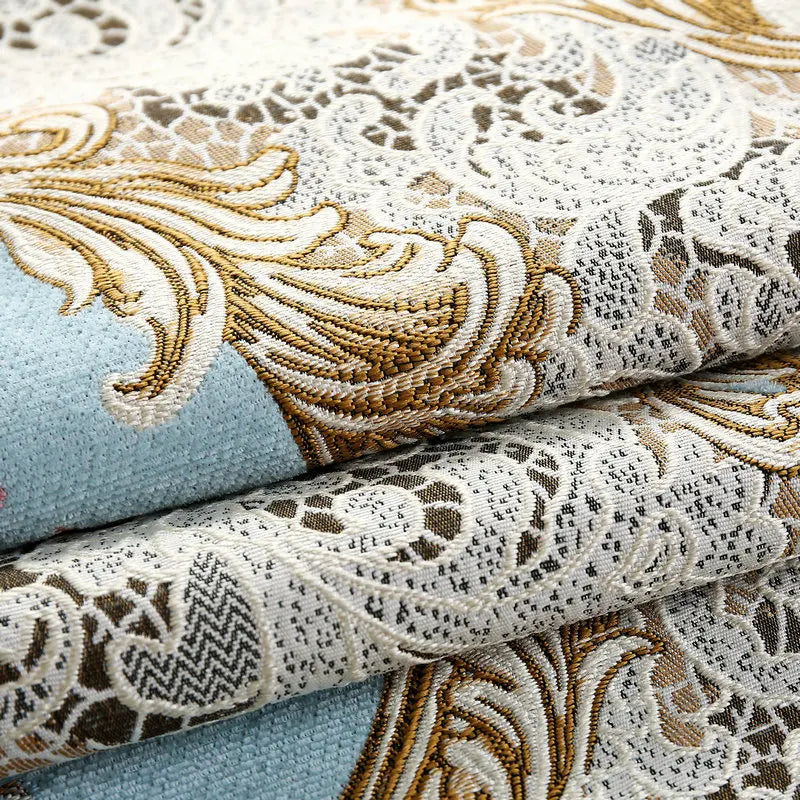 Tissu ornemental aux motifs floraux et géométriques en tons de beige, brun et bleu.