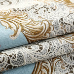 Tissu ornemental aux motifs floraux et géométriques en tons de beige, brun et bleu.