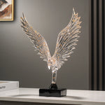 statuette animale moderne transparente dorée oiseau cerfs ailes déployées base noire