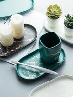assiettes ovales marbrure dorée blanc vert noir modernes rangement cuisine
