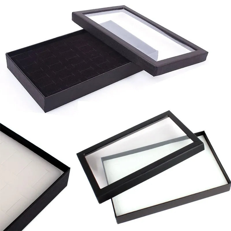 présentoir bijoux moderne boîte transparente 21.5cm 13.7cm 3.2cm alvéoles rectangulaires plusieurs bagues noires argentées