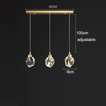 lampe suspendue or transparent cristal facettes géométriques moderne élégante tringles câbles