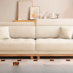 canapé places minimaliste moderne beige clair coussins ajustables table basse bois textures douces surpiqures