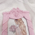 Détail du nœud rose du cadre photo