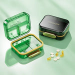 boîte rangement médicaments réutilisable transparente moderne vert bleu violet poignée dorée compartments