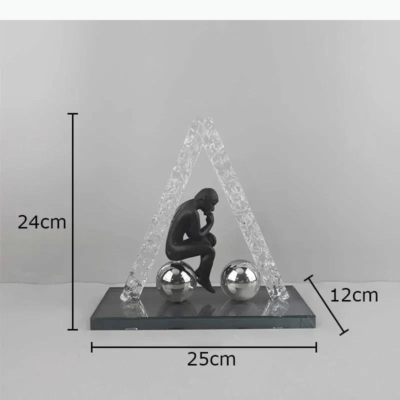 sculptures décoratives modernes homme assis sphères figures suspendues transparentes textures cristallines contemporaines