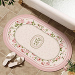 tapis bain rose clair fleurs vertes bordure ornée résistant décoloration moderne classique ovale 40x60cm