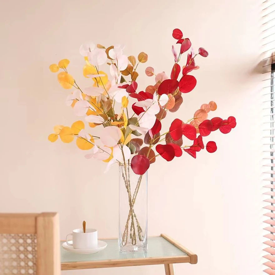 bouquet artificiel feuilles ovales moderne vase transparent support doré couleurs vives exposition intérieure