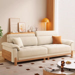 canapé places minimaliste moderne beige clair coussins ajustables table basse bois textures douces surpiqures