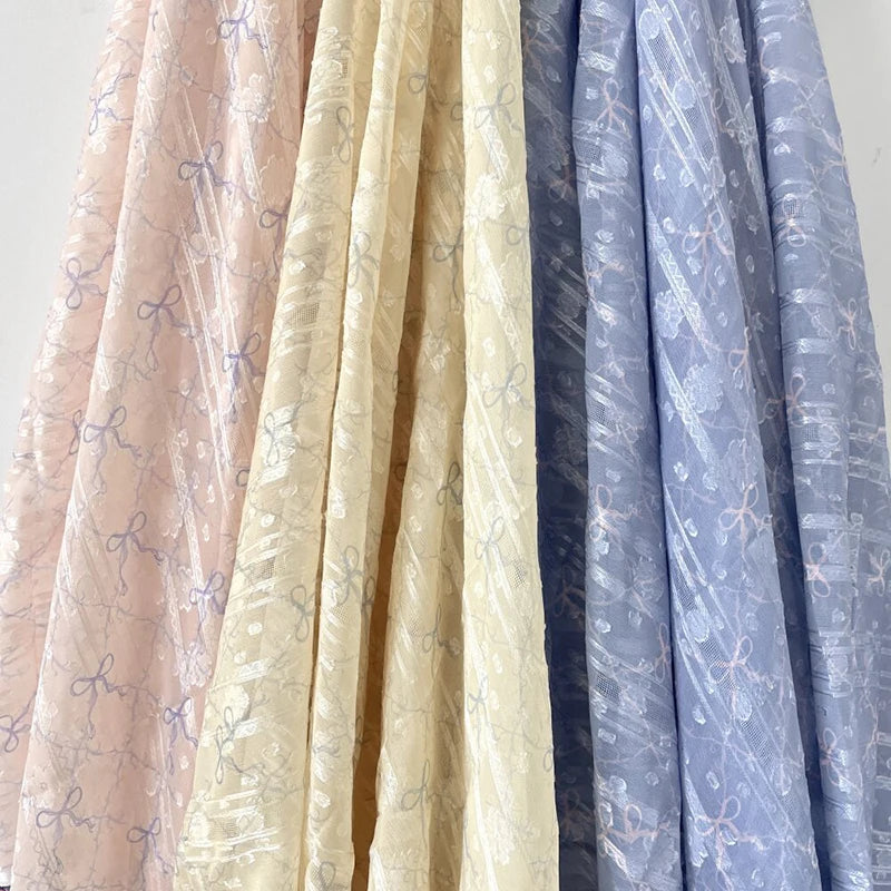 tissu polyester coton rose clair beige bleu clair motif nœuds fleurs élégant romantique 150cm