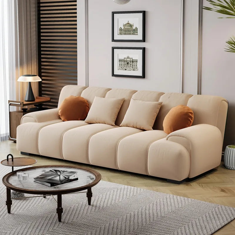 canapé angle beige motif géométrique moderne salon contemporain deux coussins orange bois pin
