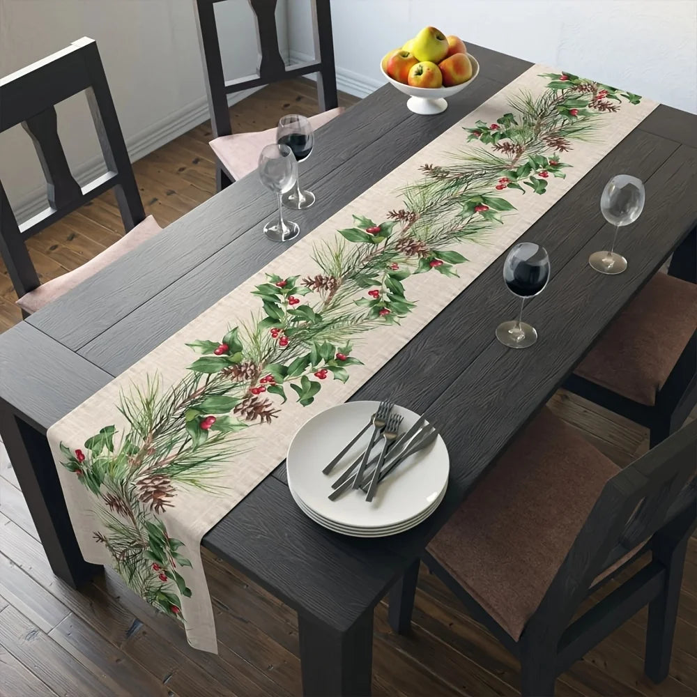 Une table en bois sombre avec un chemin de table décoré de branches de pin et de baies rouges, accompagnée de verres de vin et d'une assiette blanche.