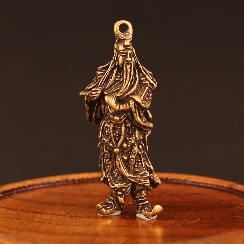 figurine traditionnelle bronze doré personnage masculin détails sculptés vêtements coiffure élaborée ornement maison