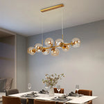 Suspension lumineuse moderne sphères transparentes dorées structure métallique noir chambre salon