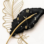 horloge murale moderne élégante noir doré feuille stylisée sans tic tac chambre coucher decoration