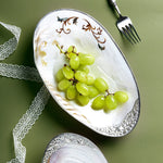 assiette ovale motifs floraux ornementations multicolores classique élégant fruits décoratif blanc table manger
