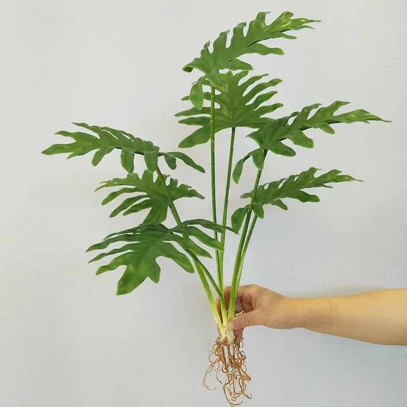 plantes artificielles vertes feuilles larges moderne decoration intérieure feuilles nervures perforations racines apparentes minimaliste