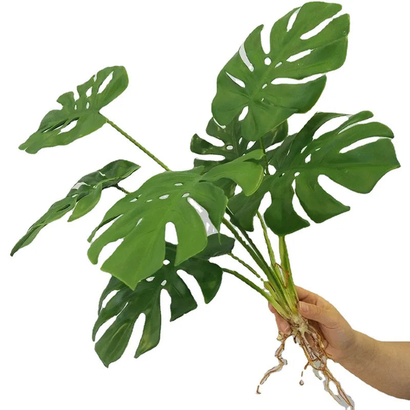 plantes artificielles vertes feuilles larges moderne decoration intérieure feuilles nervures perforations racines apparentes minimaliste