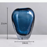 vase moderne transparent bleu foncé bulles fleurs artificielles feuilles bougie minimaliste