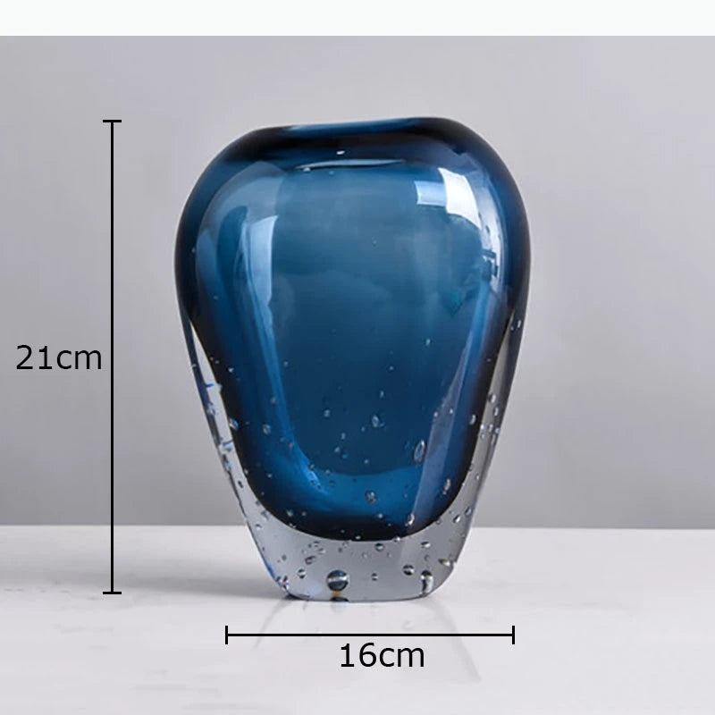 vase moderne transparent bleu foncé bulles fleurs artificielles feuilles bougie minimaliste