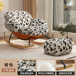 fauteuil bascule moderne beige noir orange roulettes coussin repos minimaliste salon