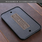 plateau thé noir insert doré traditionnel asiatique service table texture bois clair tasses théière
