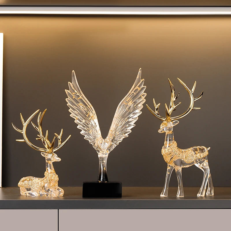 statuette animale moderne transparente dorée oiseau cerfs ailes déployées base noire