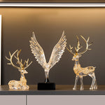statuette animale moderne transparente dorée oiseau cerfs ailes déployées base noire