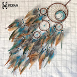 attrape rêves ethnique attrape rêves artisanal plumes bois marron bleu gris blancsuspendu fil