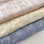 tissu polyester coton rose clair beige bleu clair motif nœuds fleurs élégant romantique 150cm